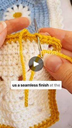 someone is crocheting the stitches on a piece of yarn