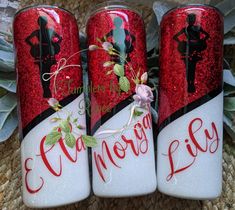 three red and white canisters decorated with silhouettes