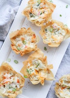 small appetizers are sitting on a white tray