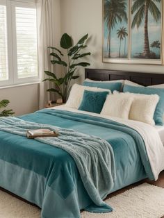 a bed with blue and white comforters in a bedroom