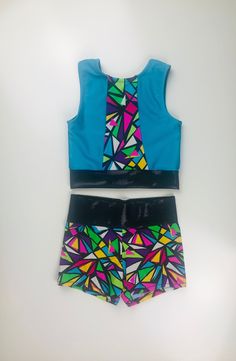 This two piece set includes a sleeveless top and a high-waisted booty short. The top is lined in the front. This set is available in sizes 4-14. Please allow 2-4 weeks for construction and shipping times as all orders are made to order. Fitted Sets With Built-in Shorts, Fitted Multicolor Party Shorts, Fitted Sets With Built-in Shorts For Summer, Fitted Sleeveless Tops For Cheerleading, Summer Fitted Sets With Built-in Shorts, Fitted Multicolor Tops Matching Set, Fitted Multicolor Matching Set Bottoms, Fitted Party Sets Short Length, Fitted Multicolor Two-piece Set