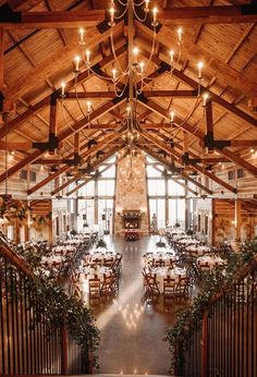 the inside of a restaurant with tables and chandeliers