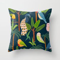 a blue pillow with colorful birds and palm trees on it