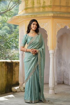 Gorgeous sea green tussar georgette saree is a perfect choice for weddings and festive occasions!. It has an embroidered border and comes with a beautiful embroidered blouse. Disclaimer: The actual product may vary slightly from the image. These are custom orders, hence expect slight variation in color, placement of the motif or buta. ESTIMATED DELIVERYBecause this is a custom order, it would take about 4 weeks from the date of purchase. RETURN POLICYThis product is a custom order and cannot be returned or exchanged. Green Art Silk Pre-draped Saree With Embroidered Border, Designer Green Pre-draped Saree With Embroidered Border, Wedding Pre-draped Saree With Embroidered Border In Slub Silk, Festive Green Pre-draped Saree With Embroidered Border, Reception Saree With Embroidered Border In Chinon, Chinon Saree With Embroidered Border For Reception, Green Embroidered Border Saree For Reception, Reception Saree With Embroidered Border, Green Banarasi Silk Saree With Embroidered Border