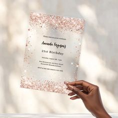 a woman holding up a birthday card with glitter on it