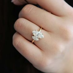 a woman's hand with a diamond ring on it