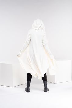 "This asymmetrical and modern cloak with hood has two side pockets, super comfy hood and thumb holes for a fabulous look. The model in the picture is 176cm. ⅼ 5.8 ft. tall and is wearing size S / color: Off White 🌟 INFO: * Worldwide EXPRESS shipping - please provide a phone number for shipping documents * US Sizing XS to 4XL - size chart available below - all measurements of the body * We offer customization to Personal Measurements & Larger Sizes 5XL, 6XL, 7XL .... 🌟 MATERIAL & CARE * Winter Hoodie With Thumbholes, Winter Long Sleeve Outerwear With Thumbholes, Elven Cloak, Fantasy Cloak, Cloak With Hood, Wool Cloak, Shipping Documents, Winter Cloak, Futuristic Clothing