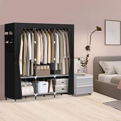 a bedroom with a bed, dresser and clothes rack in it's center area