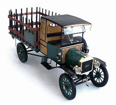 an old model car with a wooden fence on the top and side, parked in front of it