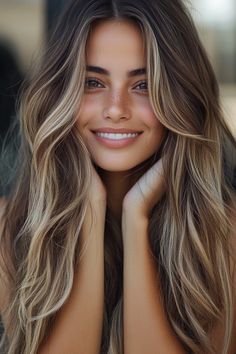 Smiling woman with long wavy hair and freckles. Best Hair For Green Eyes And Pale Skin, Brunette Hair Color With Highlights Caramel, Country Girl Hair Color, Brown Hair With Bright Highlights, Brown Hair With A Little Blonde, Brunette Hair Ideas Colors, Long Brown Hair With Blonde Highlights, Fall Hair Trends 2024 Color, Fall Hair Color Ideas For Blondes