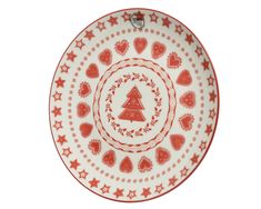 a red and white plate with hearts, trees and stars on the rim is shown