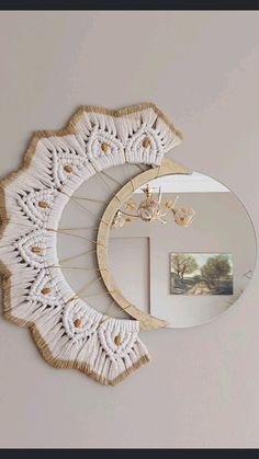 a mirror and some white doily on a wall