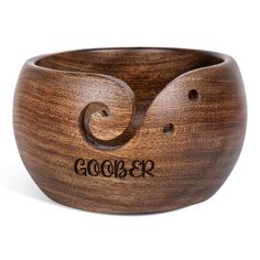 a wooden bowl with the word goober carved into it's side and inside