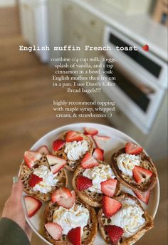 a person holding a plate with toast and strawberries on it