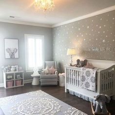 a baby's room is decorated in gray and white