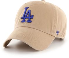 the los angeles dodgers'47 hat is tan and has blue embroidered letters on it