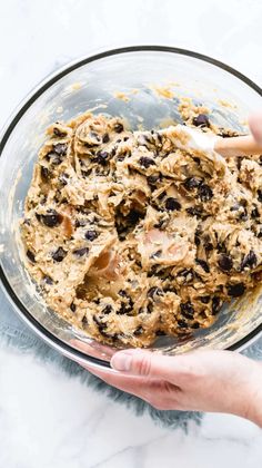 someone is mixing ingredients in a glass bowl