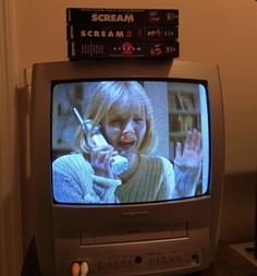 an old television sitting on top of a wooden table