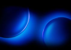 two blue circles on a black background with some light coming from the top and bottom