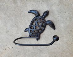 a turtle shaped hook on the side of a wall