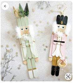 two wooden nutcrackers are hanging on the wall