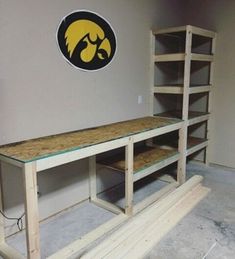 a room with some shelves in it and a michigan logo on the wall behind them