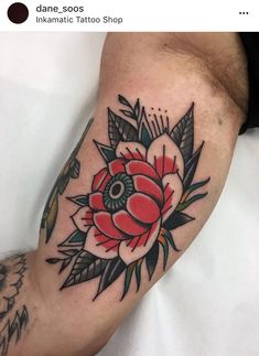 a man with a flower tattoo on his arm