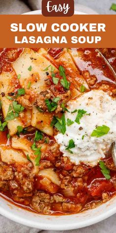 easy slow cooker lasagna soup in a white bowl topped with sour cream and parsley