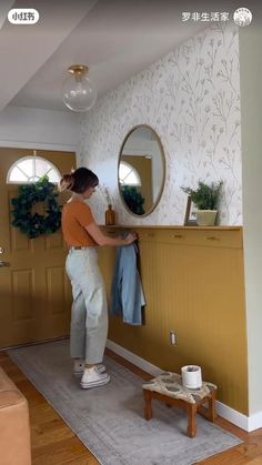 a woman standing in front of a mirror