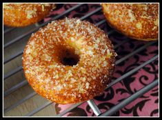 three donuts sitting on top of a metal rack