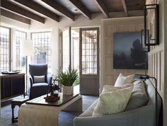 a living room filled with furniture and lots of windows