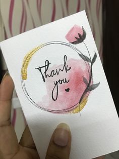 a person holding up a card with the words thank you