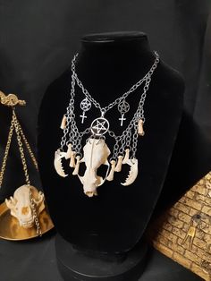 Have a Look at This Gorgeous Mink Skull and Bone Necklace! It is Made with Real Bones, and a Stainless-Steel Witches Pentagram in the Center.  It Has Two Real Mink Jawbones And Two Real Coyote Foot Bones Hanging to the Sides of the Skull. The ENTIRE Necklace is Stainless Steel! It is Adjustable to 24 Inches. All Items Ship Within 1-3 Days via USPS Ground Advantage Service. Shipping on these will be 5.50 (USA Only) All additional items are FREE! International Shipping Will Be 22.00 + 2.00 For each Additional Item. Canada 20.00 + 2.00 For each Additional Item. International Shipping May Take 2 - 6 Weeks to Deliver I DO NOT Carry Human Bones or Any Sort of Illegal Items. And As Etsy Sellers, We Are Not Allowed to Sell Domesticated Dog or Cat Bones of Any Sort. All The Bones Here are Legal to Witches Pentagram, Cat Bones, Witch Pentagram, Pentagram Necklace, Witch Necklace, Wiccan Witch, Human Bones, Jewelry Gothic, Real Bones