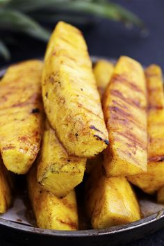 grilled pineapples in a bowl on a table