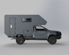 a gray truck with a camper attached to the back