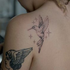 a woman with a bird tattoo on her shoulder