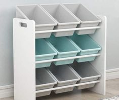 a white shelf with several bins on top of it and a rug in the background