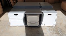 two white cabinets sitting next to each other on top of a tile floor in a room