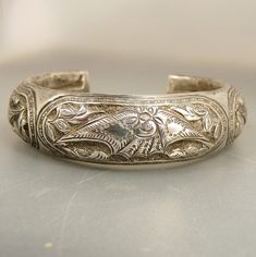 "Vintage Chinese Sterling Cuff Bracelet Repousse Lotus & Bat Wings Fabulous, Hand Chased,  Example Of Early Chinese Sterling Silver Statement Cuff Bracelet, Features Repousse Lotus Flowers  And What Appears To Be A Bat In Flight, For Longevity  This Stunning Cuff Bracelet Is Hallmarked On Each End With Chinese Characters Measuring 6\" Interior Length With An Opening Of 1 3/8\" Note !! There Is No Flexibility  To The Opening 3/4\" Width , 1/4\" Depth  42.5 Grams Weight jujubee1.etsy.com  To Brows Silver Etched Cuff Bracelet For Wedding, Ornate Engraved Cuff Bracelet For Wedding, Engraved Cuff Bangle For Wedding, Wedding Engraved Cuff Bangle, Ornate Cuff Bangle Bracelet For Anniversary, Traditional Silver Cuff Bracelet For Formal Occasions, Elegant Silver Cuff Bracelet For Festivals, Elegant Ceremonial Cuff Bracelet, Engraved Cuff Bracelet For Wedding And Festivals