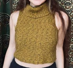 a smiling woman wearing a yellow knitted top