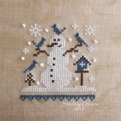 a cross stitch pattern with a snowman and birdhouse in the middle, on a beige background