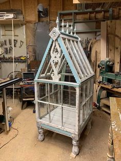 an old greenhouse is being worked on in a shop with tools and other items around it