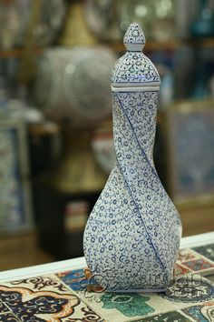 a blue and white vase sitting on top of a table