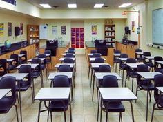 an empty classroom with desks and chairs