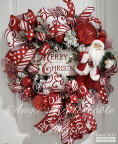 a red and white christmas wreath with santa claus