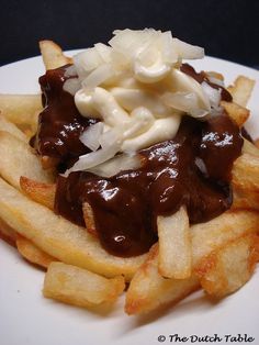 a white plate topped with fries covered in gravy