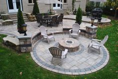 an outdoor patio with chairs and fire pit