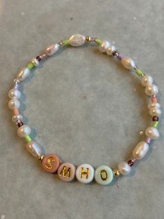 Family bracelet with the initials of all the family, it is a little treasure that all mother's love. Handmade with freshwater pearls and colorful beads, each bracelet is unique. Made with love in Barcelona, they are perfect gifts for friends or family members for birthdays, as a thank you or anniversaries.  The letters are completely up to you, initials of loved ones or the initial of the bracelet's owner as a self-love reminder. Made with an elastic band and a 14k gold pleated bead to secure th Pearl Bracelet With Letter Beads, Pearl Bracelet With Letter Beads For Gift, Adjustable Pearl Bracelet With Letter Beads, Gold Pearl Beaded Bracelets With Letter Beads, Dainty Letter Beads Beaded Bracelets For Birthday, Dainty Letter Beads Bracelet For Birthday, Gift Pearl Bracelet With Letter Beads, Dainty Beaded Bracelets With Letter Beads For Birthday, Pearl Bracelet With Letter Beads As Gift