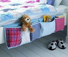 a teddy bear sitting in the pocket of a bed with books and toys on it