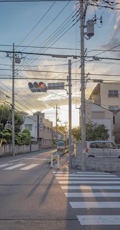 an intersection with traffic lights and buildings in the background